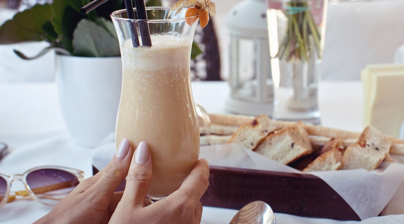 Woman holding an Espresso Frappé made with recipe from Espresso Machine Expert